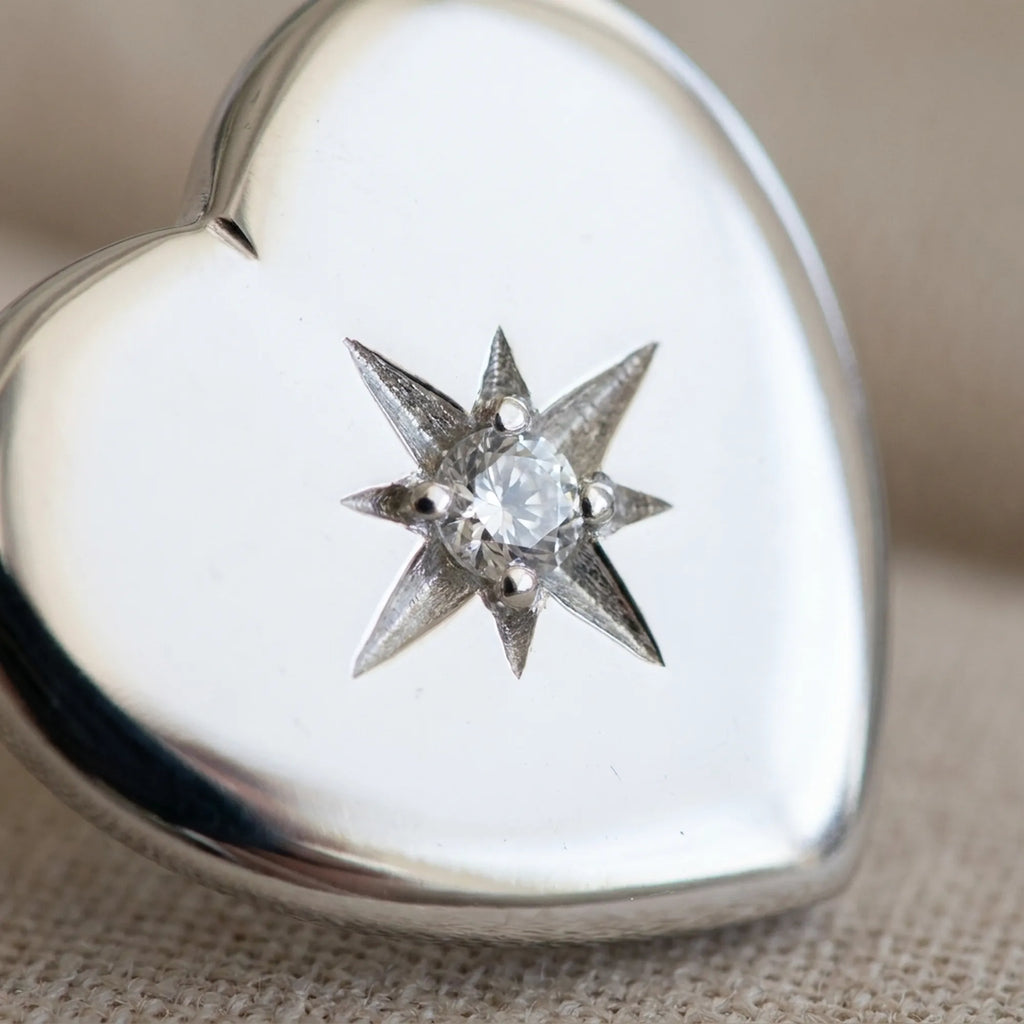 Close-up of north star CZ engraving on rhodium silver puffed heart stud earring — 8-pointed star, 925 sterling silver