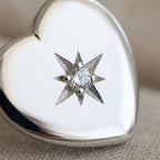 Close-up of north star CZ engraving on rhodium silver puffed heart stud earring — 8-pointed star, 925 sterling silver