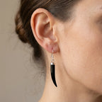 Black onyx horn dangle earring worn on model — 925 silver shepherd hook, natural stone, warm neutral background