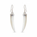 A pair of drop earrings featuring curved, ivory-colored mother of pearl horns set in polished silver-tone metal with silver French hook ear wires, shown against a plain white background in Dubai.