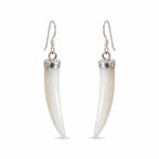A pair of drop earrings featuring curved, ivory-colored mother of pearl horns set in polished silver-tone metal with silver French hook ear wires, shown against a plain white background in Dubai.