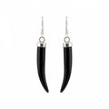 A pair of black horn or bone dangle earrings with polished silver-toned metal caps and fishhook wires, shown against a plain white background in Dubai.