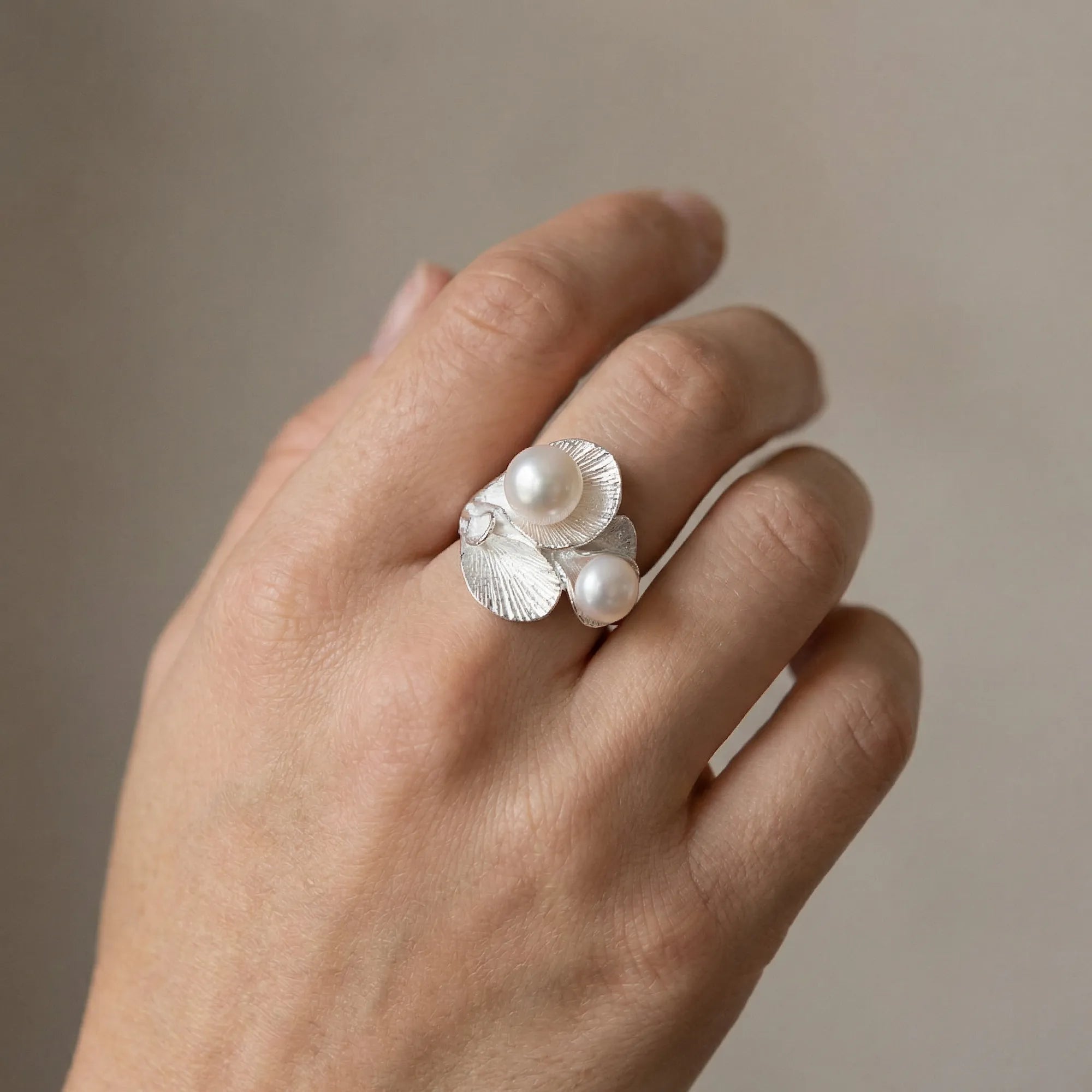 Model wearing 925 silver hosta leaf twin pearl statement ring, hand shot