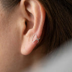Rear view of silver ear cuff no piercing on model — rounded ends gripping ear securely