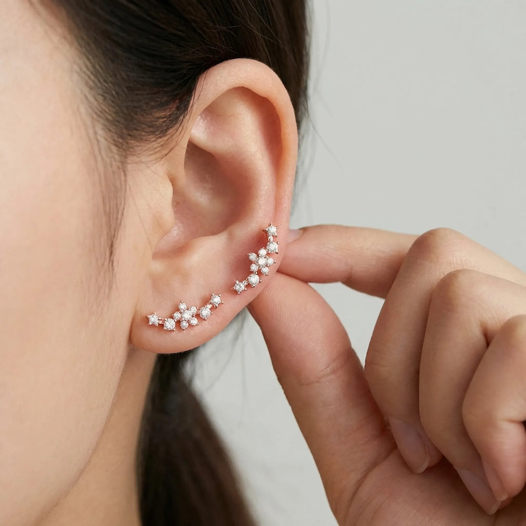 Close up of a woman easily adjusting the stackable rose gold ear cuff, demonstrating how it sweeps securely up the ear.