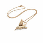 Gold-plated sterling silver hummingbird pendant necklace with a fine chain on a white background UAE.