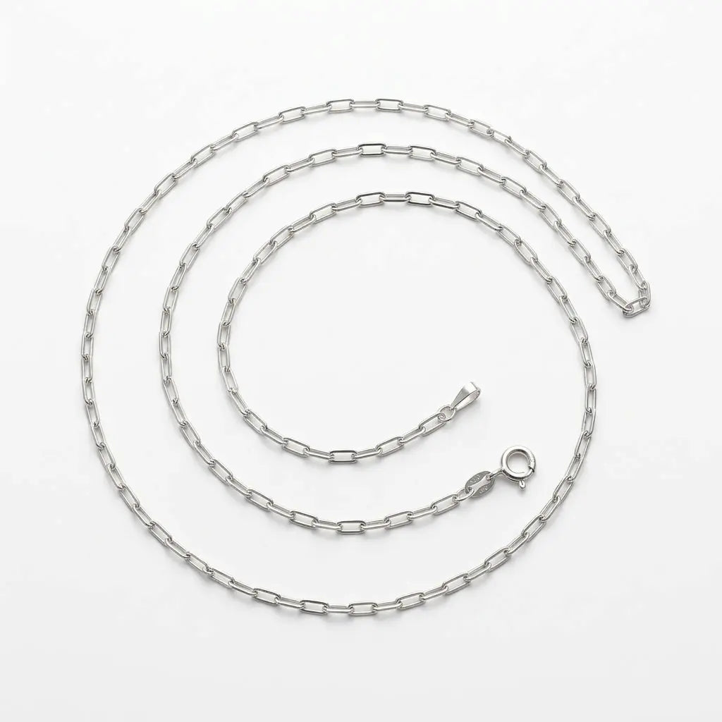 Italian-made 925 sterling silver paperclip chain with elongated rectangular links and spring-ring clasp, arranged on white.
