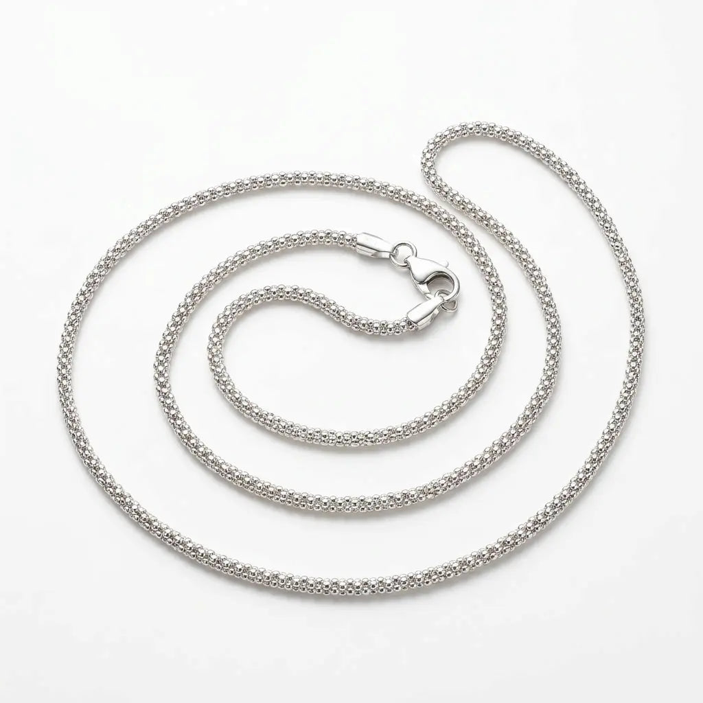 Italian-made 925 sterling silver round popcorn chain with closely textured links and lobster clasp against a white background.