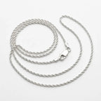 Fine 925 sterling silver rope chain arranged on a white background, showing its closely twisted links and lobster clasp.