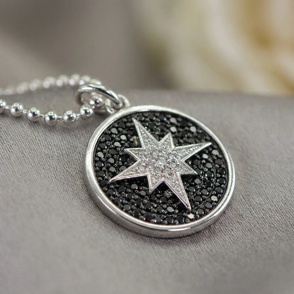 Close-up macro shot highlighting the intricate full pave black and white CZ setting on the sterling silver star pendant jewelry dubai.