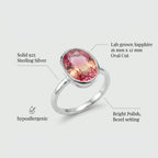 Technical infographic detailing the Lab Grown Padparadscha Sapphire Ring specs, including solid 925 sterling silver, 16x12mm oval cut, and hypoallergenic finish.