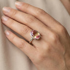 Model wearing the Lab Grown Padparadscha Sapphire Ring on her hand to demonstrate the 11.45-carat gemstone size and 2mm flat band fit.
