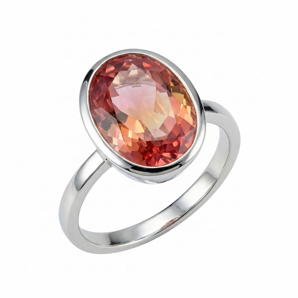 Front view of the Lab Grown Padparadscha Sapphire Ring featuring an 11.45-carat oval cut gemstone in a 925 silver bezel setting.