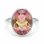 Top-down angle of the Lab Grown Padparadscha Sapphire Ring showcasing the faceted oval cut stone and bright polished 925 silver band.