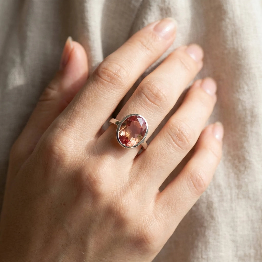 Close-up of the Lab Grown Padparadscha Sapphire Ring styled on the finger, showing its stackable design and seamless fit.