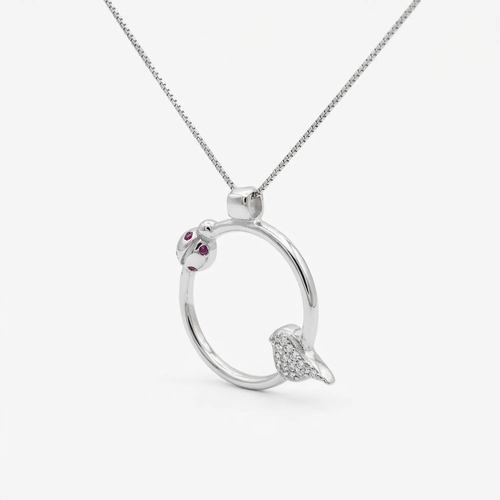 Forty-five degree angle of the rhodium plated ladybug necklace highlighting the spring design bird charm