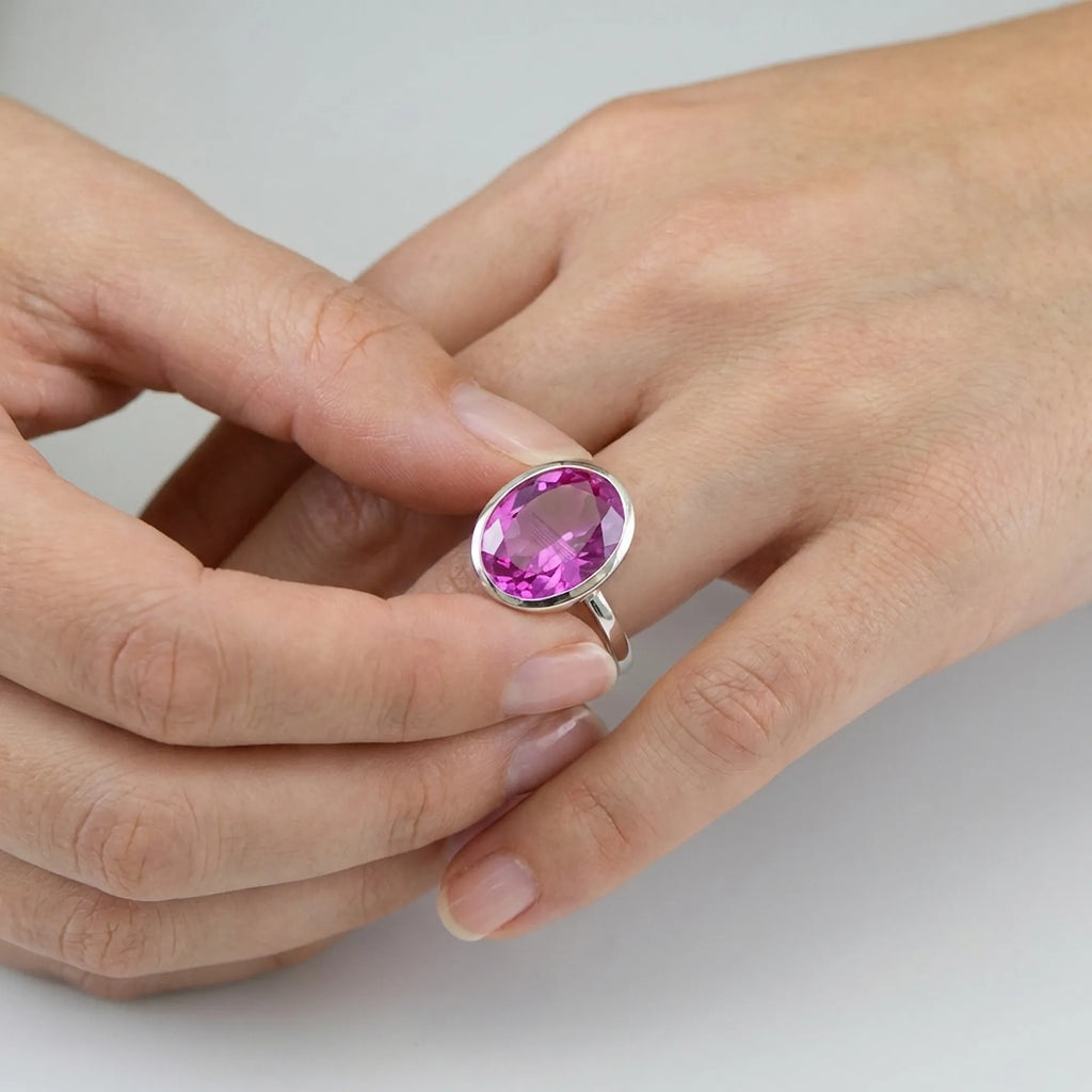 Styling the Large Oval Pink Purple Quartz Ring on the finger paired with cozy knitwear, showcasing comfortable everyday wearability.
