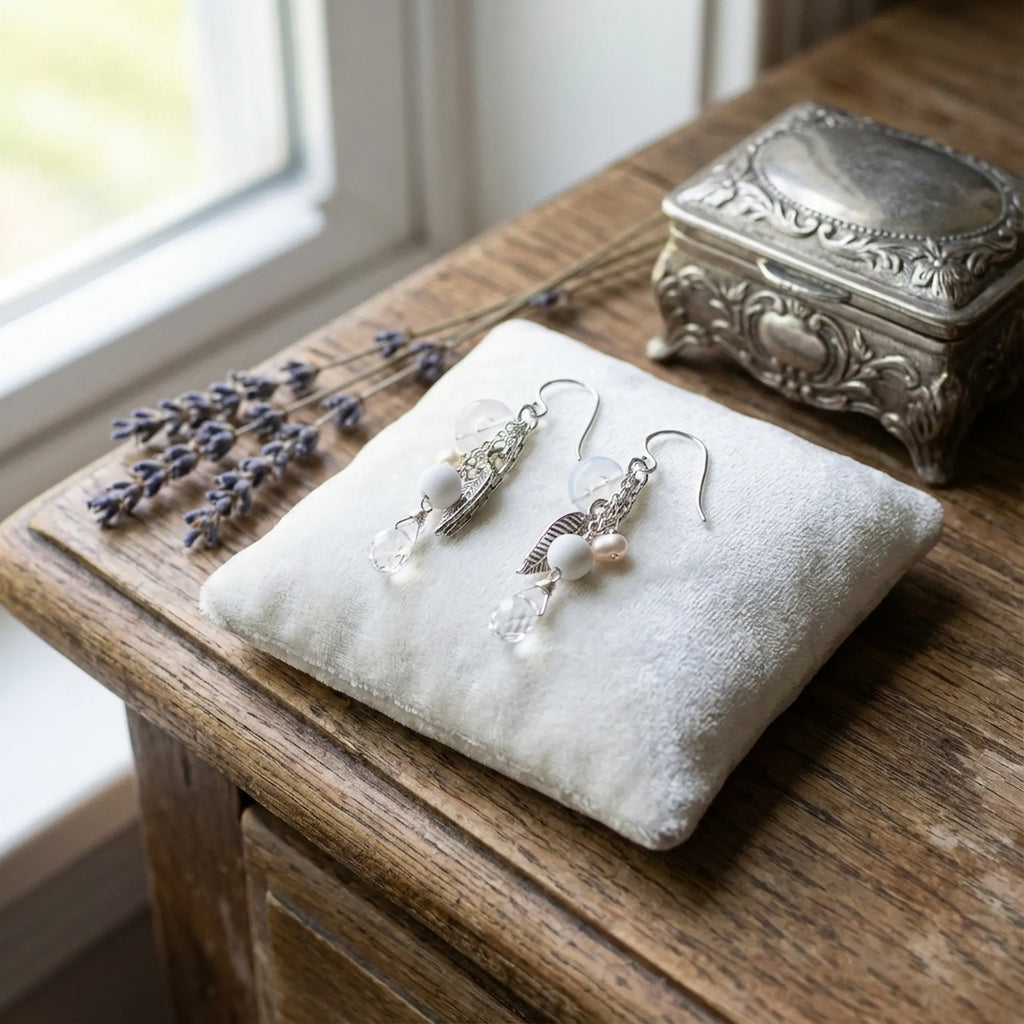 A beautiful angled view showing the intricate layered design of these 925 sterling silver leaf chain drop earrings with snow quartz.
