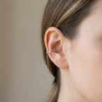 Model wearing a silver leaf-vine ear cuff on the conch with no piercing, Luna Dura Dubai.