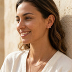 18K rose gold plated 925 sterling silver antler stud earrings worn by a woman outdoors in Dubai.