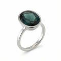 Discover our stackable London Blue Topaz ring featuring a deep teal oval gemstone in a snag-free 925 sterling silver bezel setting.