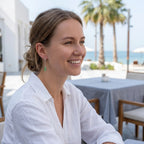Model wearing sage green lucite cone drop earrings at Dubai beachside restaurant — 925 silver minimalist earrings UAE