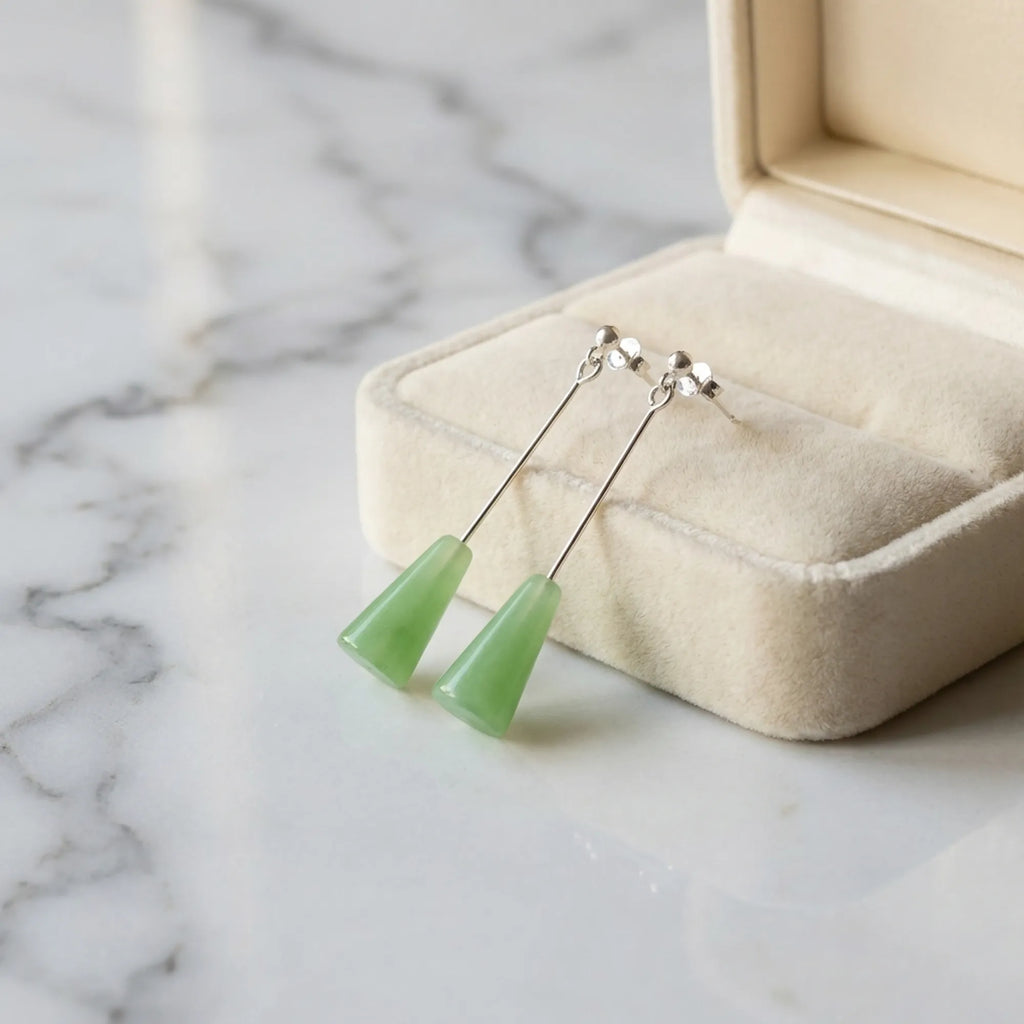 Sage green lucite cone drop earrings in cream velvet jewelry box on marble — minimalist gift earrings Dubai