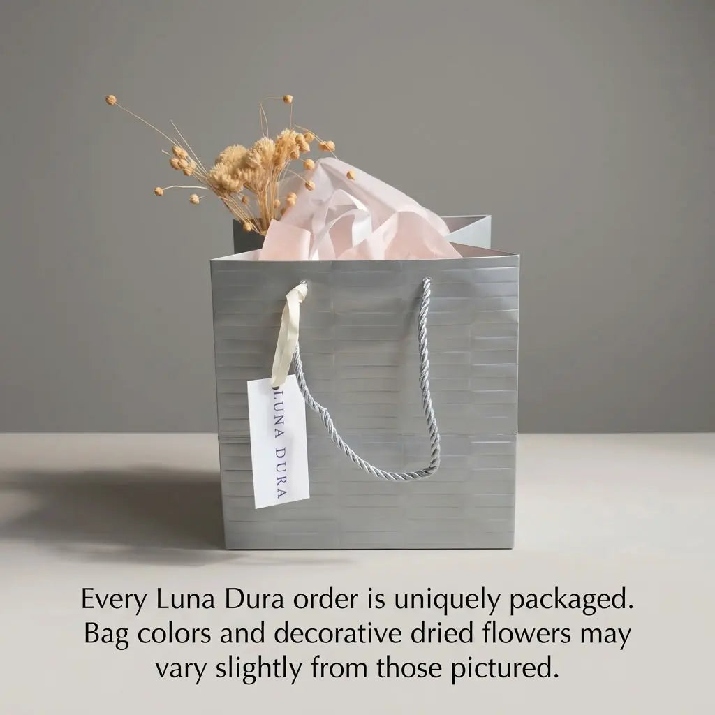 Luna Dura Dubai jewellery gift packaging with silver-toned bag, tissue paper and dried flowers; presentation may vary