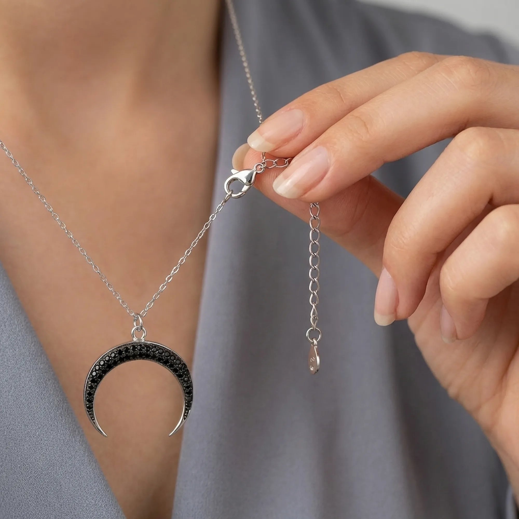 Detailed view of the adjustable 925 sterling silver extender chain and lobster clasp on the Luna Dura black zircon crescent moon necklace