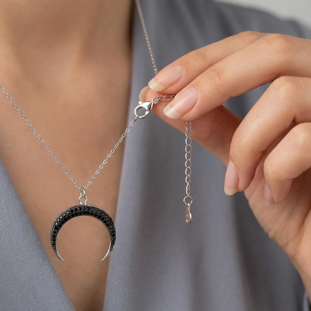 Adjustable 925 silver chain extender and lobster clasp detail on crescent necklace