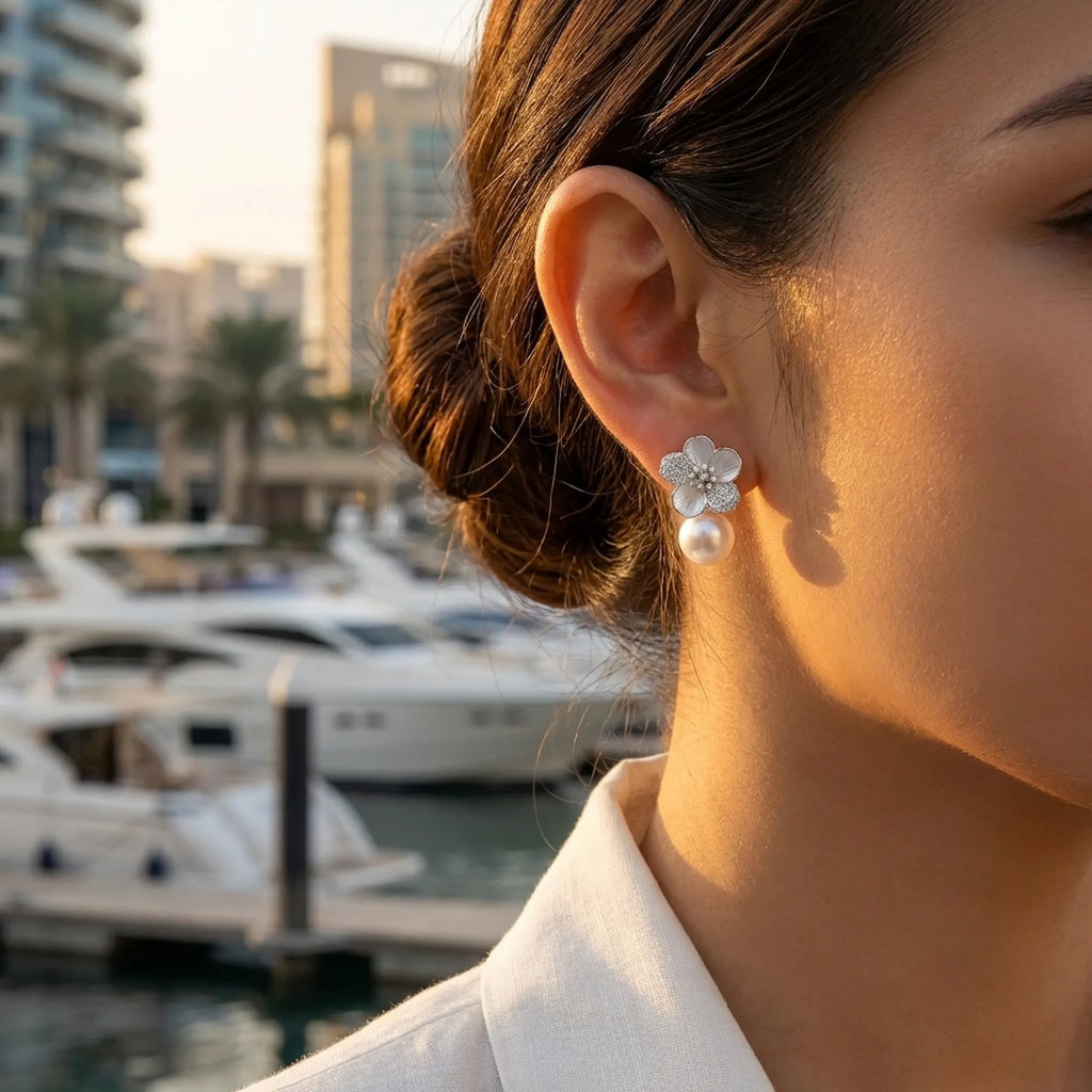 Woman looking towards a sunset marina wearing luxury jewelry gift for her anniversary.