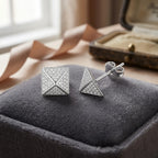 Macro of micro-pavé CZ on 925 silver pyramid stud — four triangular faces, rhodium finish detail
