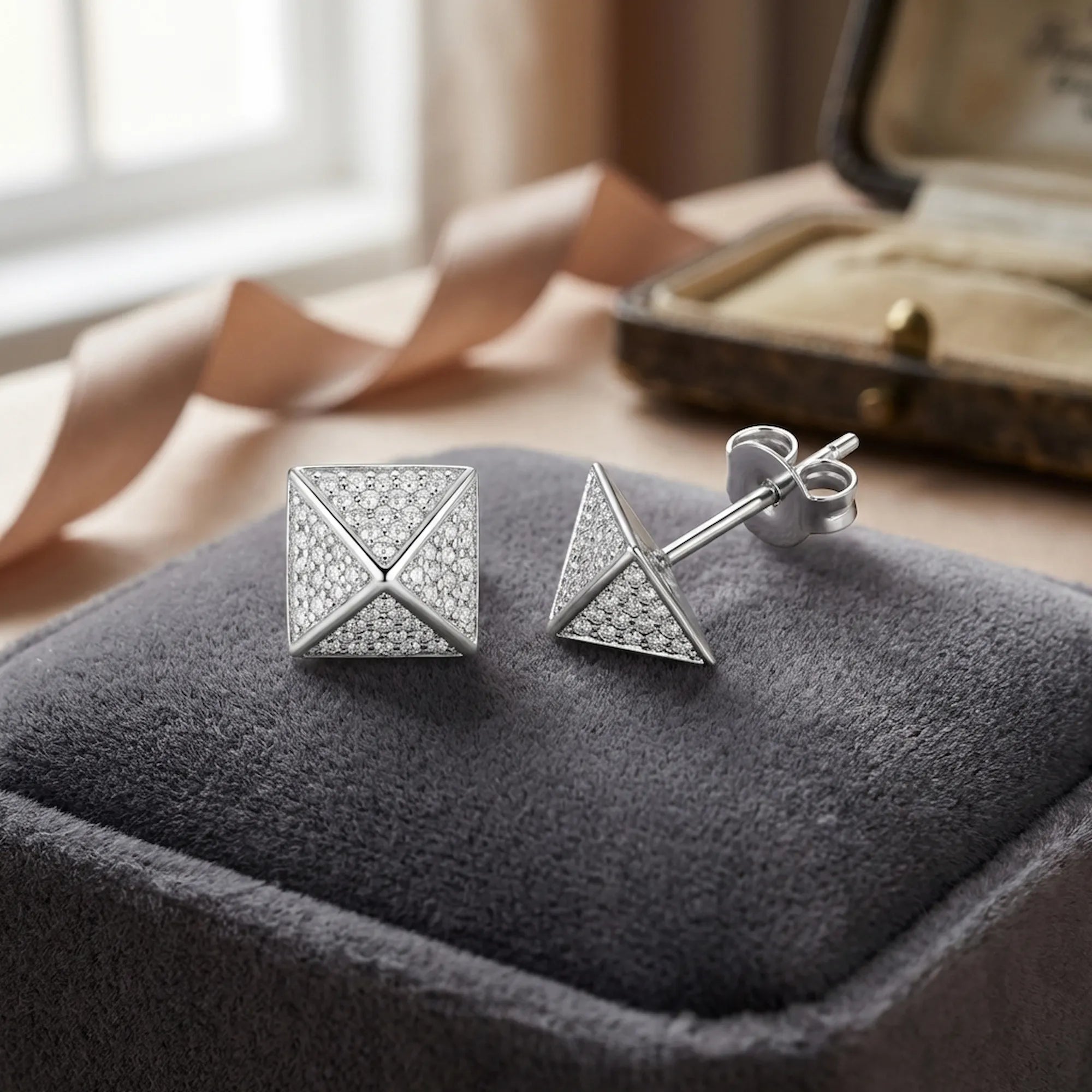 Macro of micro-pavé CZ on 925 silver pyramid stud — four triangular faces, rhodium finish detail