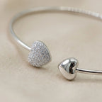 Macro detail shot highlighting the premium rhodium finish on the 925 silver solid collar necklace, focusing on the intricate CZ pave heart pendant.