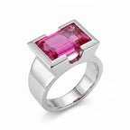 Emerald cut magenta quartz ring in 925 sterling silver, half bezel setting, angled view, white background