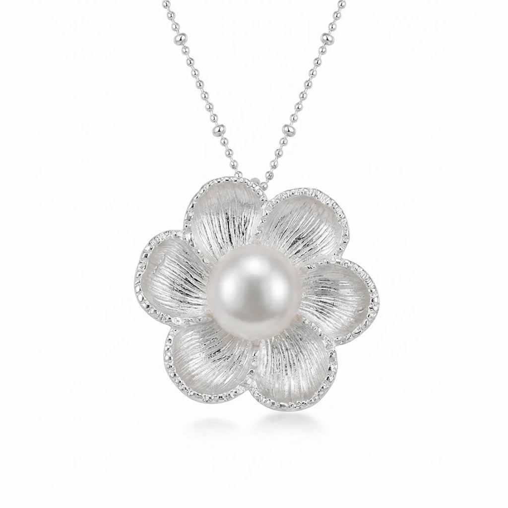 Six-petal magnolia pearl pendant necklace in 925 silver, white background front view