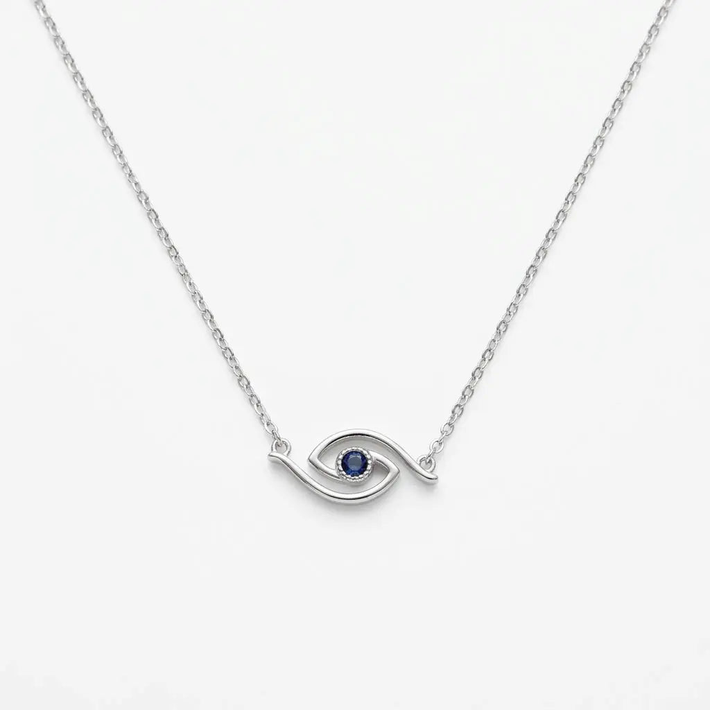 Minimalist blue CZ evil eye station necklace in polished 925 silver on white, showing its curved openwork eye motif.