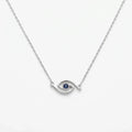 Minimalist blue CZ evil eye station necklace in polished 925 silver on white, showing its curved openwork eye motif.