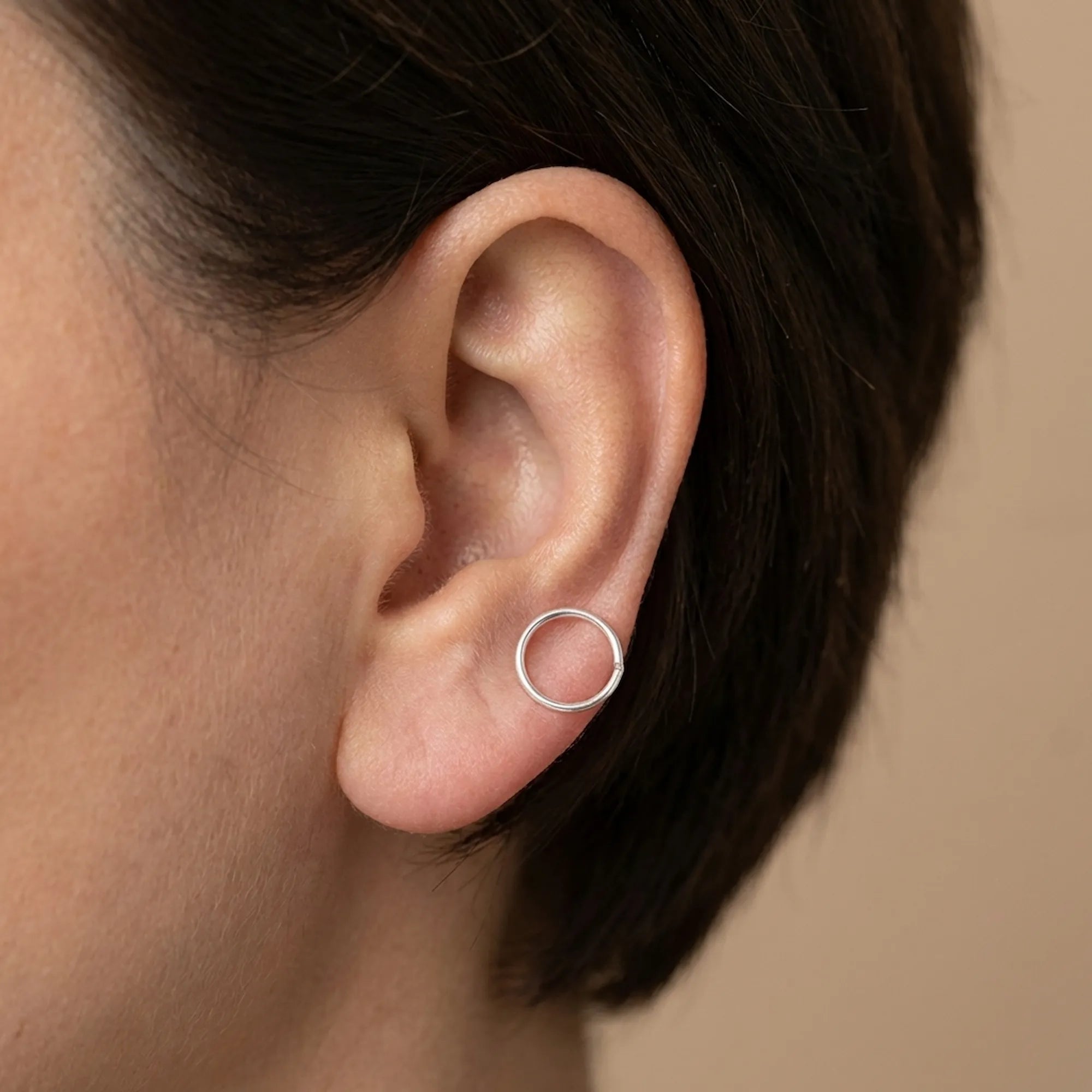 Model wearing 10mm 925 silver ear cuff on lower lobe — scale and daily wear fit reference