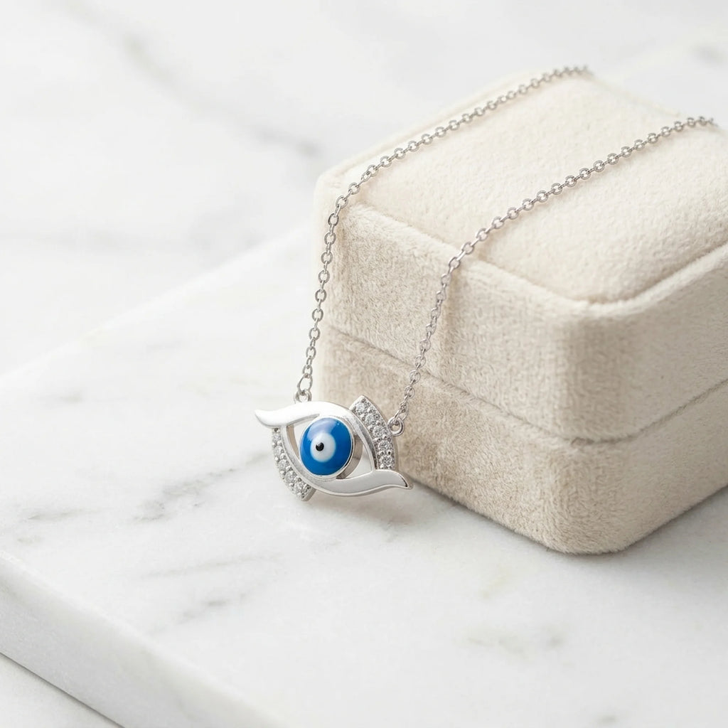 Modern evil eye pendant design with 925 silver, blue enamel, and cubic zirconia on a jewelry box in dubai.