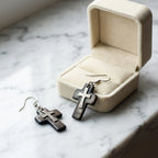 Tahitian black Mother of Pearl cross earrings beside cream velvet jewelry box on marble — faith gift earrings Dubai UAE