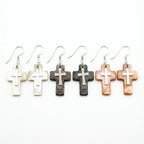 Natural shell cross drop earrings in three colorways — white lip oyster, Tahitian black and winged oyster brown — 925 silver crucifix on white background