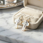 White Mother of Pearl cross drop earrings in open cream velvet jewelry box on marble — natural shell cross gift earrings UAE