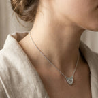Mother of Pearl bow heart necklace on model neck showing 40cm chain fall and collarbone placement — rhodium silver 925 Dubai