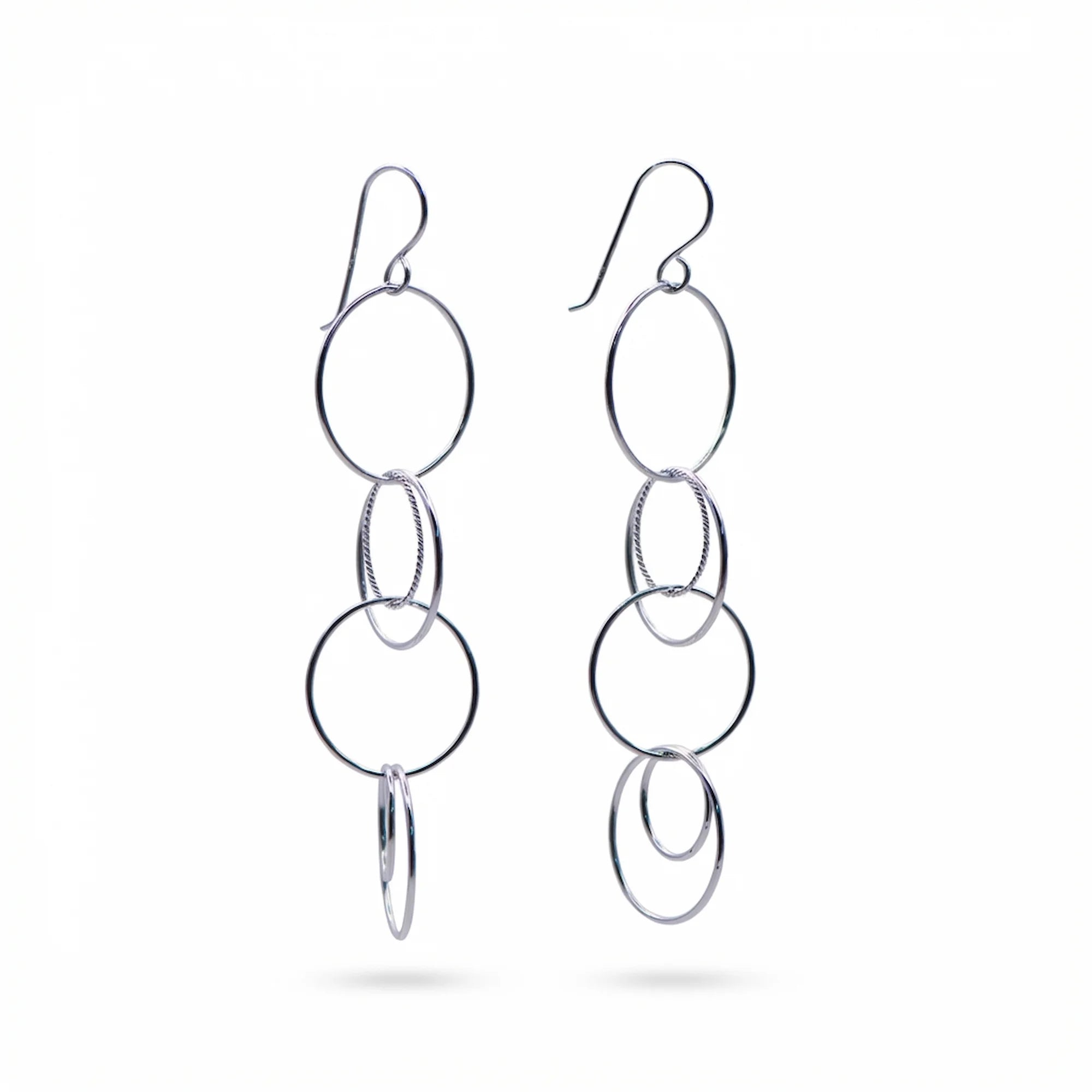 Multi-circle drop earrings in rhodium-plated sterling silver featuring a twisted-wire center ring, available in Dubai.