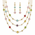 18k gold-plated layered necklace and earrings set with multicolored round stones displayed on a white background in Dubai.