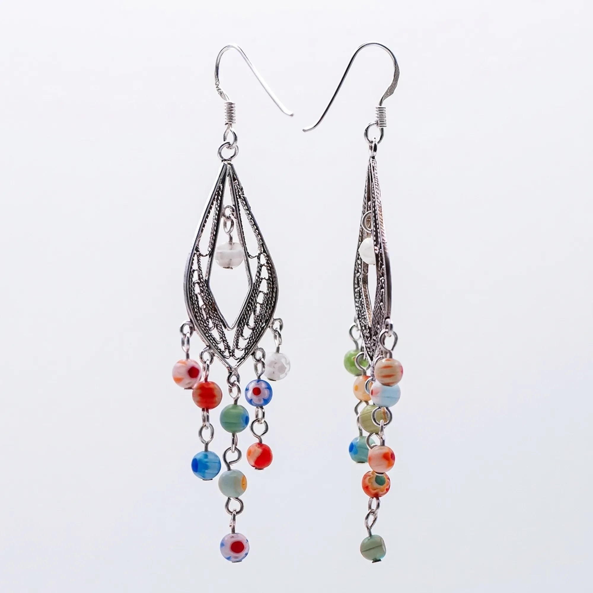 Murano glass chandelier earrings with silver filigree and millefiori beads, Luna Dura Dubai.