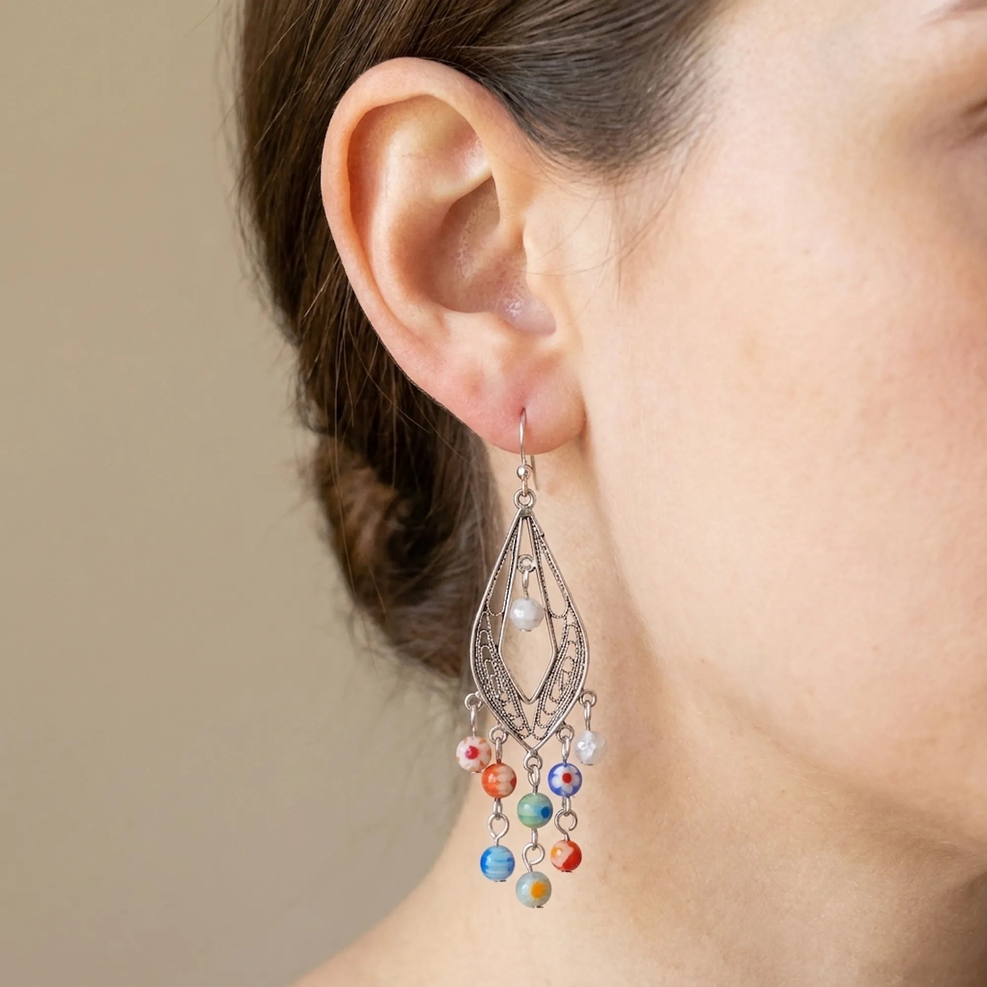 Close-up of a silver filigree Murano glass chandelier earring with colourful beads, Luna Dura Dubai.