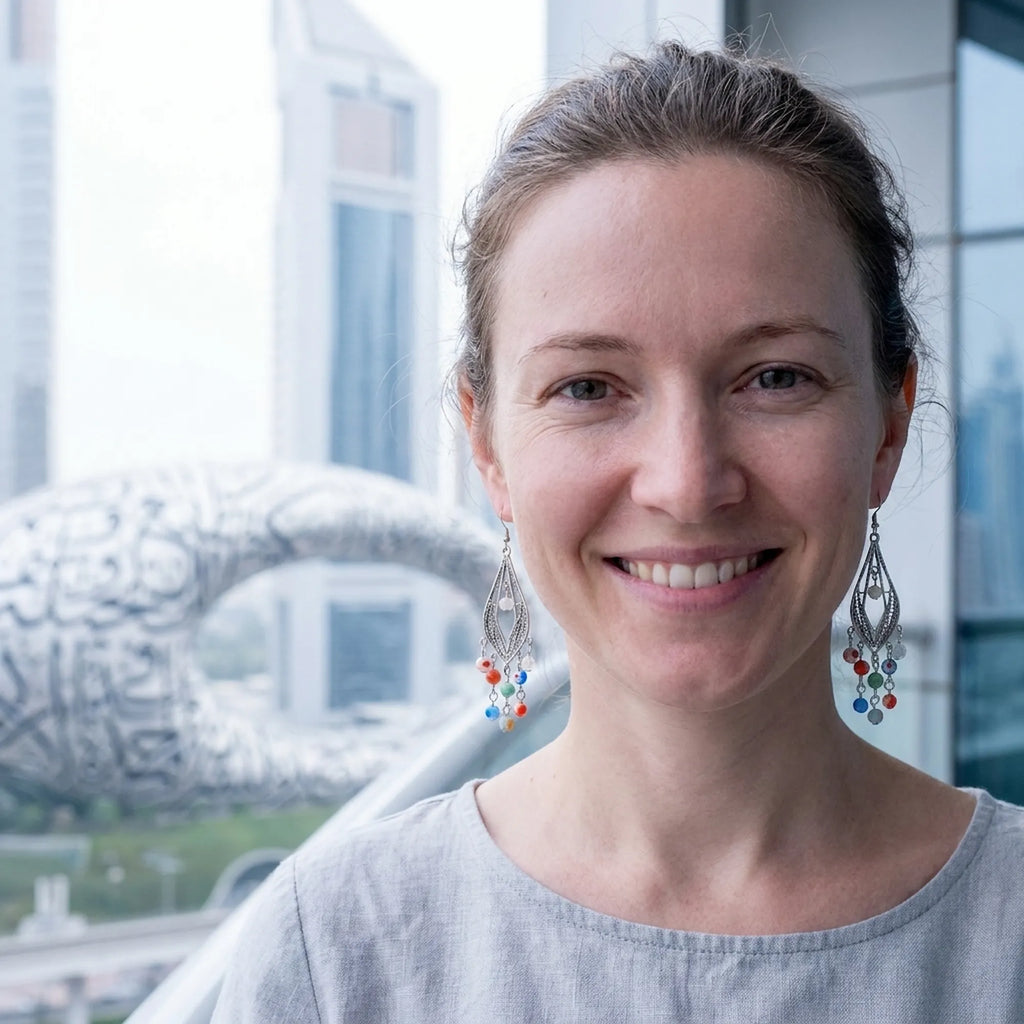 Woman wearing Murano glass chandelier earrings by the Museum of the Future, Dubai.