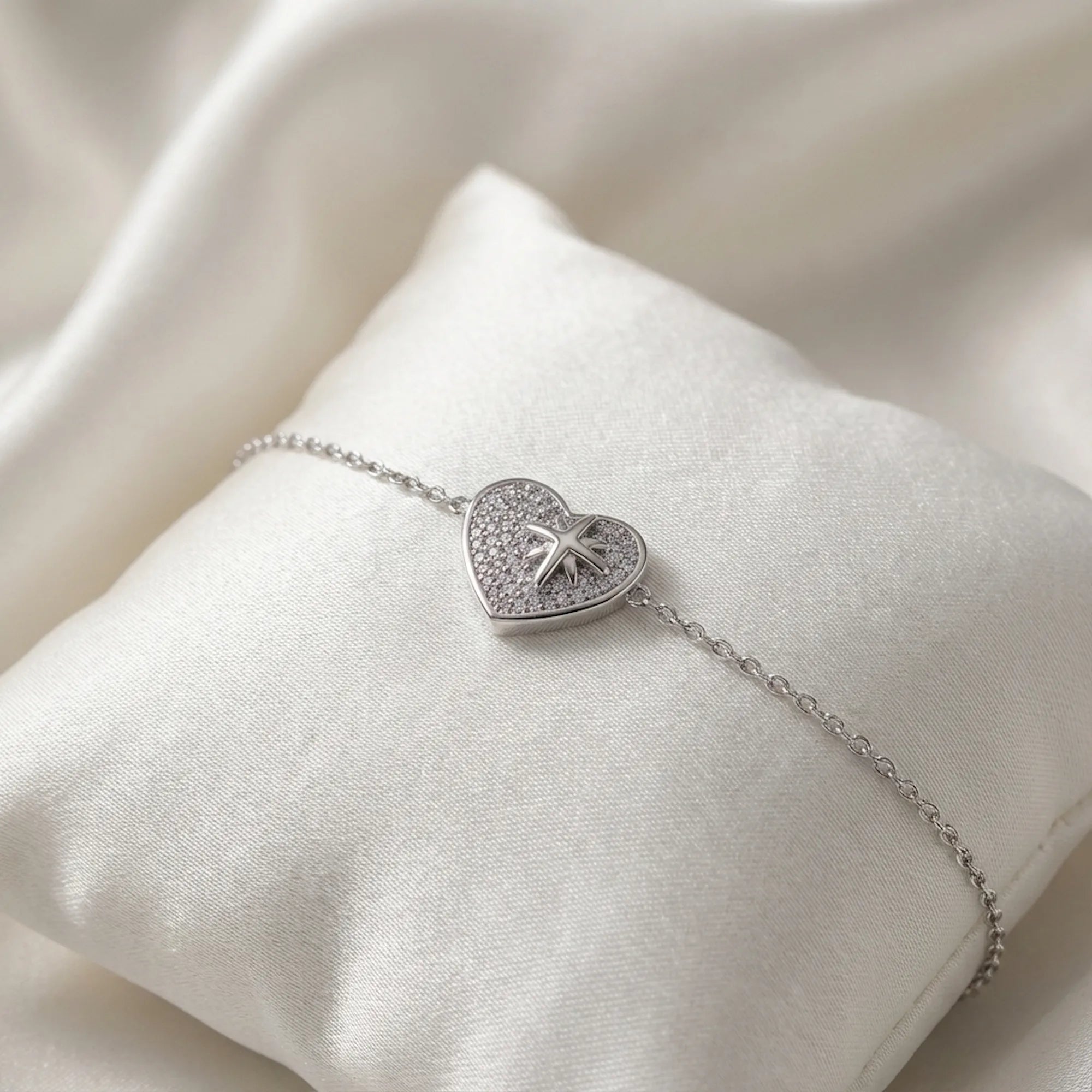 North Star pavé heart bracelet on white satin cushion — rhodium 925 silver gifting presentation Luna Dura Dubai UAE